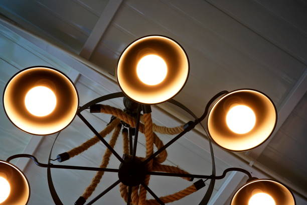 istock Light bulb is hanging under a house roof 1347245836