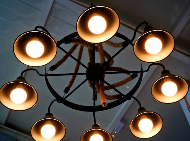 istock Light bulb is hanging under a house roof 1347245841