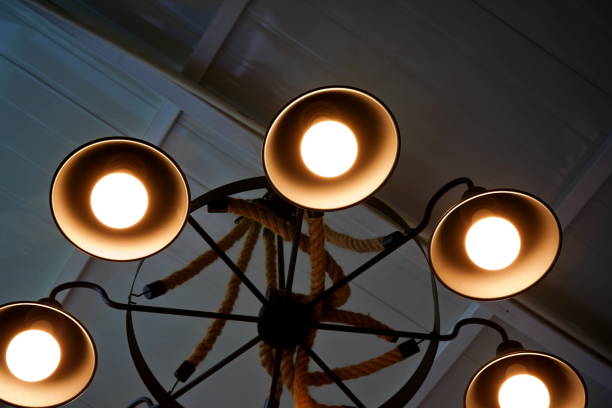 istock Light bulb is hanging under a house roof 1347245980