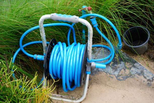 istock Garden hose for watering plants in garden 1347247565