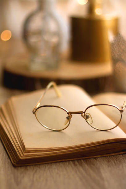 istock Book, Reading Glasses and Candles 1347248121