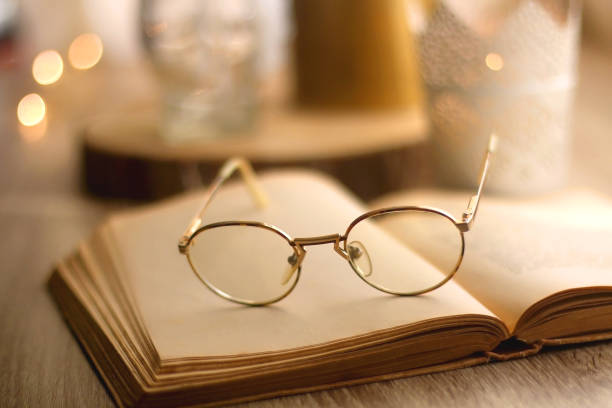 istock Book, Reading Glasses and Candles 1347248134