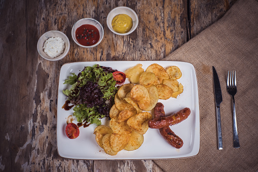 Appetizers - Potato chips, salad and sausage