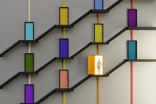 An abstract staircase and multi colored doors, individual one is open and a man going in, symbolizing choice concept. ( 3d render )
