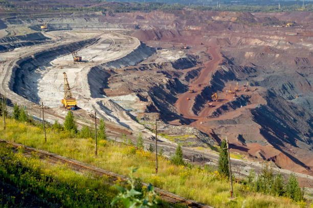 istock Concept of mineral development - panorama of operating ore mine. 1347249596
