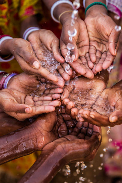 istock Hands of poor - African children asking for drinking water 1347249668