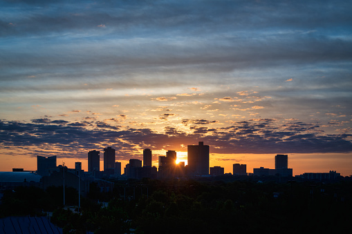 Fort Worth skyline, looking east, at sunrise as sun peeks between buildings