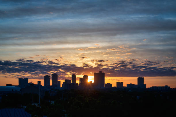 Fort Worth skyline at sunrise Fort Worth skyline, looking east, at sunrise as sun peeks between buildings fort worth stock pictures, royalty-free photos & images