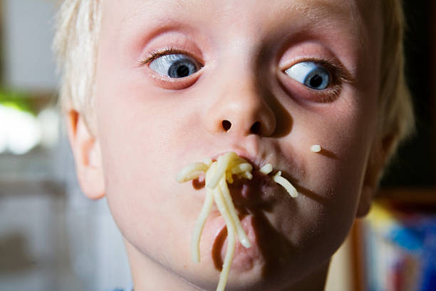 istock Spaghetti face as little boy attempts to eat pasta 134725002