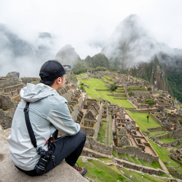 istock Young Asian man traveler looking at Machu Picchu 1347252491