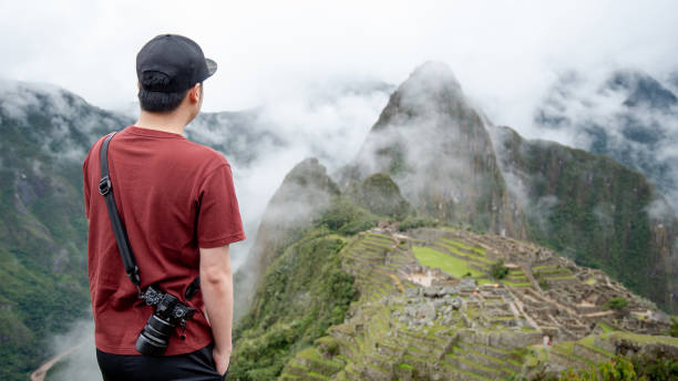 istock Young Asian man traveler looking at Machu Picchu 1347252517