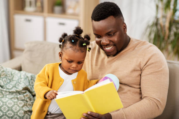 istock african father reading book for baby daughter 1347252683