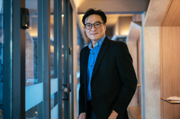 istock Successful senior Asian businessman standing in office 1347252715