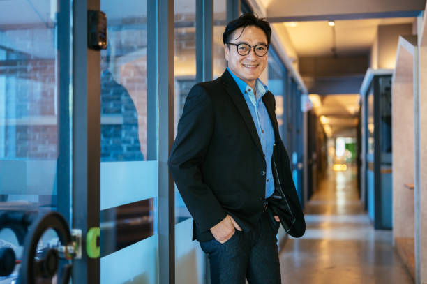 istock Successful senior Asian businessman standing in office 1347252753