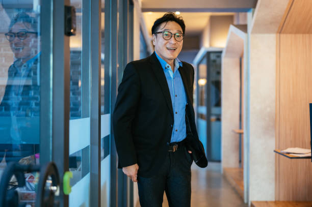 istock Successful senior Asian businessman standing in office 1347252767