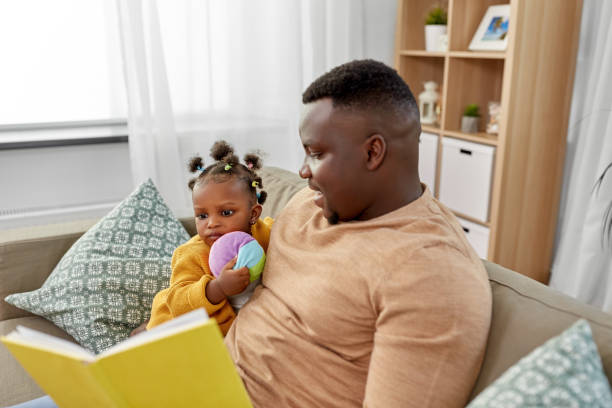 istock african father reading book for baby daughter 1347253442