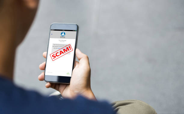 Text message SMS scam or phishing concept Man hands using smart phone phone spam photos stock pictures, royalty-free photos & images