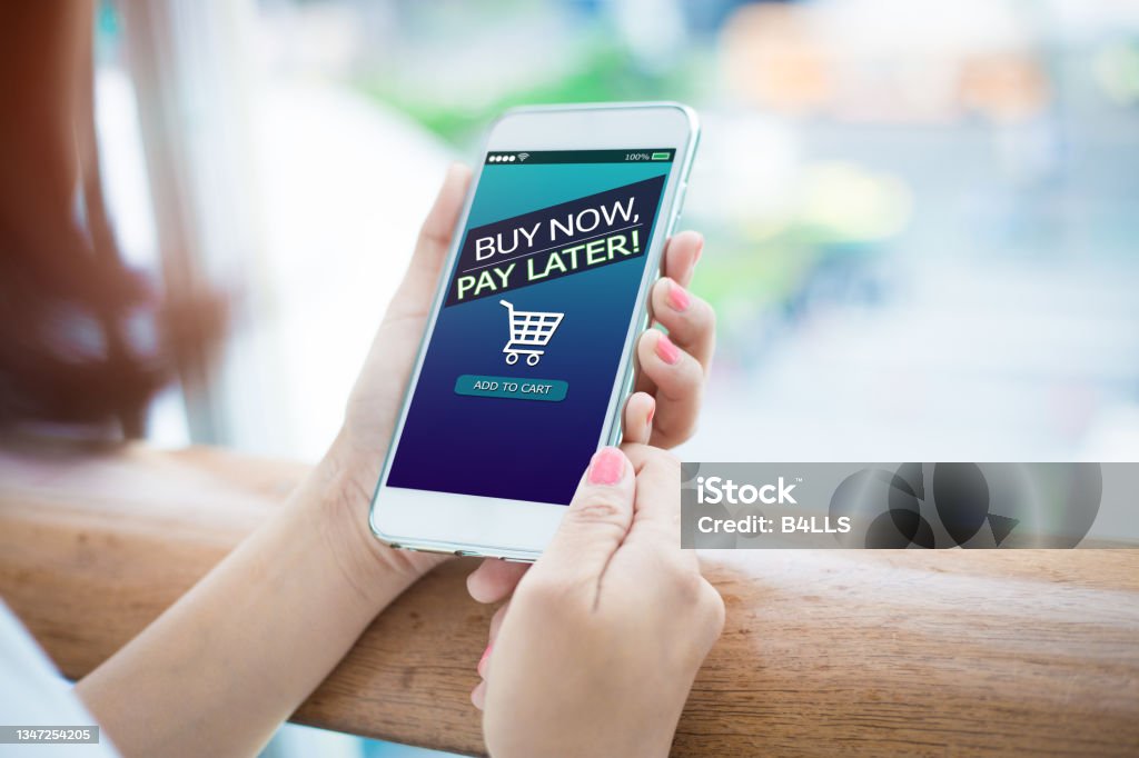 BNPL Buy now pay later online shopping concept. Hands holding mobile phone Paying Stock Photo