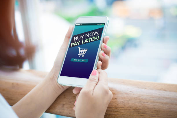 BNPL Buy now pay later online shopping concept. Hands holding mobile phone deadline photos stock pictures, royalty-free photos & images