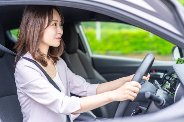 istock Young woman driving a car 1347255576