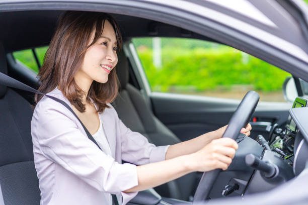 istock Young woman driving a car 1347255584