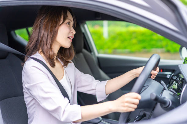 istock Young woman driving a car 1347255590