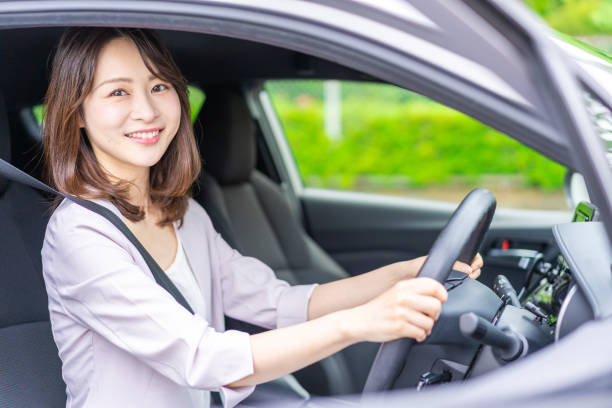 istock Young woman driving a car 1347255597