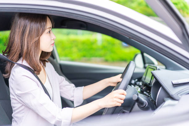 istock Young woman driving a car 1347255621