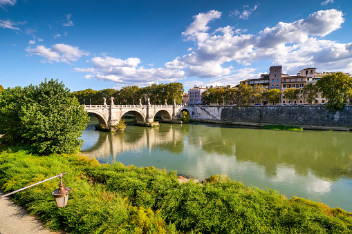 The first colors of autumn paint the banks of the Tiber river in the historic heart of Rome, with the Ponte Sant'Angelo in the background. In 1980 the historic center of Rome was declared a World Heritage Site by Unesco. Image in high definition and 16:9 format.