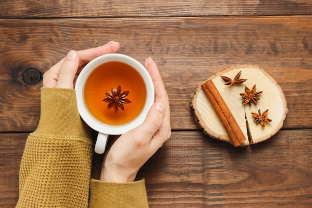 istock Female hands hold cup of tea with spices 1347257274