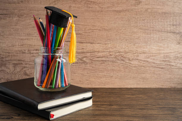 istock Graduation hat with colorful pencils on book with copy space, learning university education concept. 1347258161