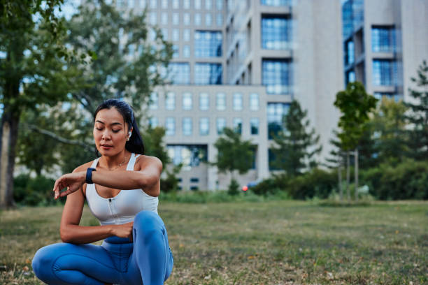 istock Young sportswoman looking and touching on smartwatch screen while exercise outdoors 1347259243