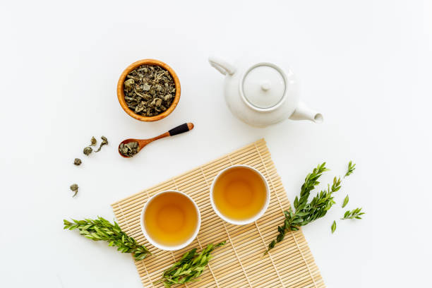 istock Ceramic white teapot and black tea in two cups, top view 1347260457