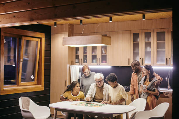 istock Family playing board game at home 1347262786