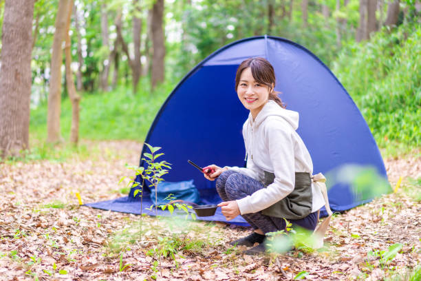 istock Young woman enjoying solo camping 1347263019