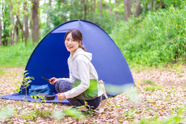 istock Young woman enjoying solo camping 1347263024