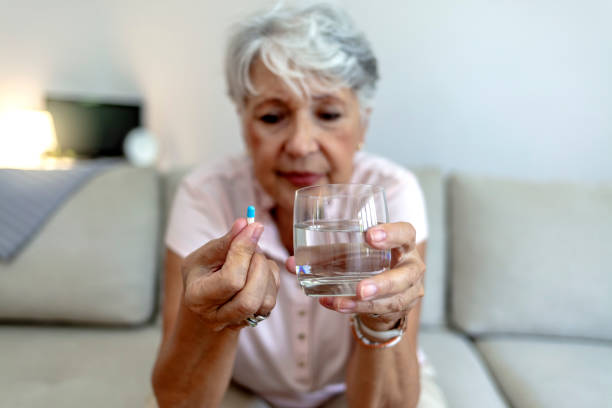 istock Woman taking medication for her illness. 1347263175