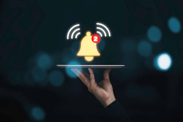 istock Businessman holding tablet with virtual yellow bell ringing for application notification alert concept. 1347264393