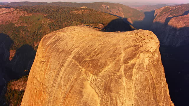AERIAL Half Dome rising above the landscape of Yosemite National Park at sunrise
