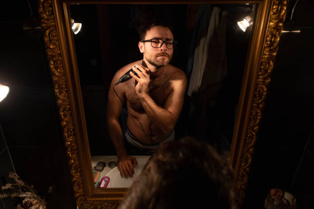 istock A man trims his beard in front of the mirror 1347264538