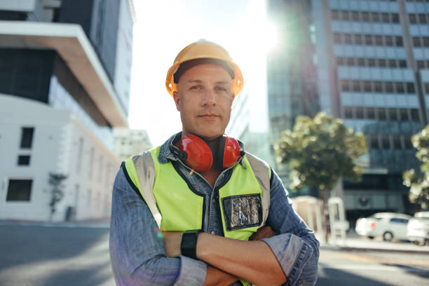 istock Confident construction worker looking at the camera outdoors 1347265953
