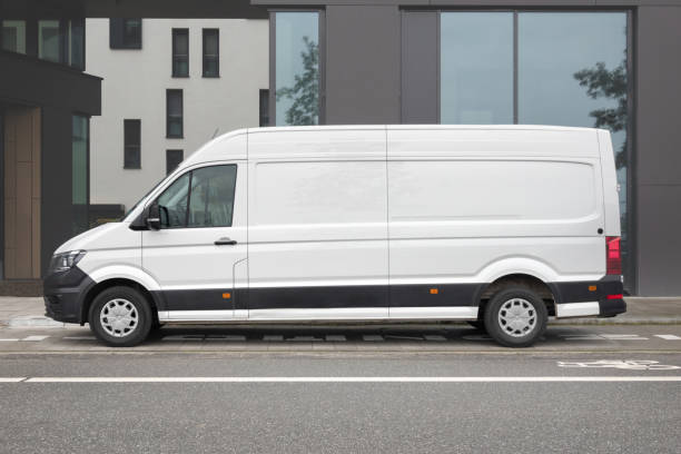 white van parked in the city - transportation delivering land vehicle car imagens e fotografias de stock
