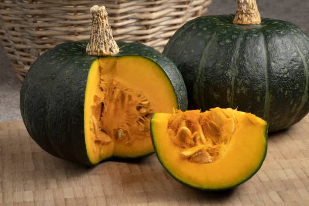 istock Fresh green whole Kabocha pumpkin and a cut close up 1347266018