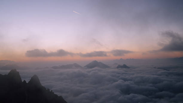 istock Majestic sharp peak against sunset sky. Snowy mountain landscape, clouds in the valley 1347271768