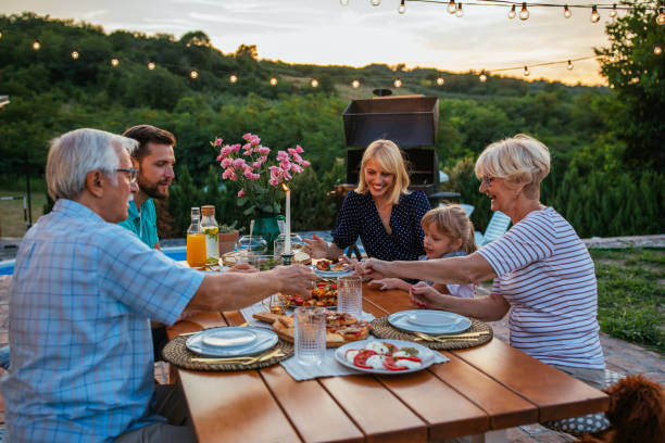 istock Affectionate family enjoying dinner during their get together in the backyard 1347271850