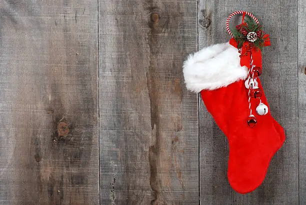 Photo of Christmas sock and wreath on wood