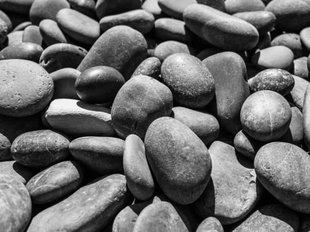 istock Tulane River Stones Smooth Bright Overhead Sunlight Close-up b/w 1347277901