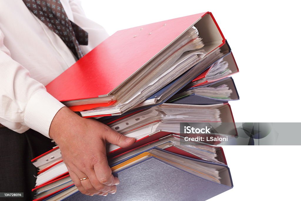 man holding stack of folders  - Isolated man holding stack of folders Pile with old documents and bills. Isolated on white background Adult Stock Photo