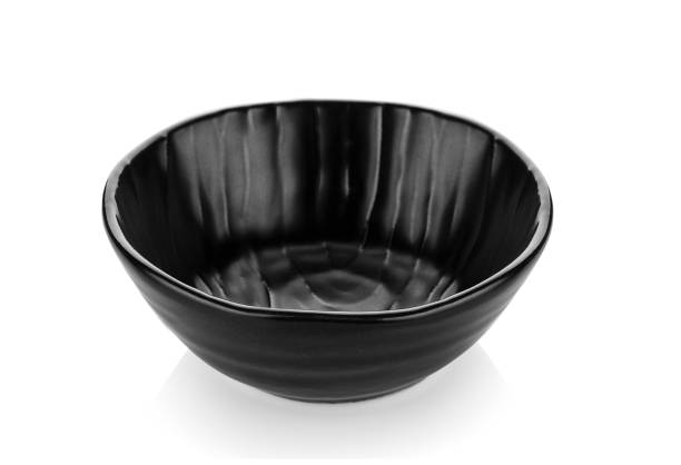 istock Beautiful shape ceramic black bowl on white background 1347282501