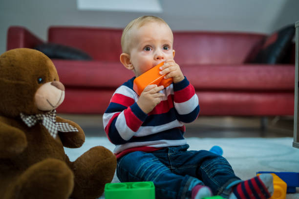 istock Baby boy playing on the floor 1347282612